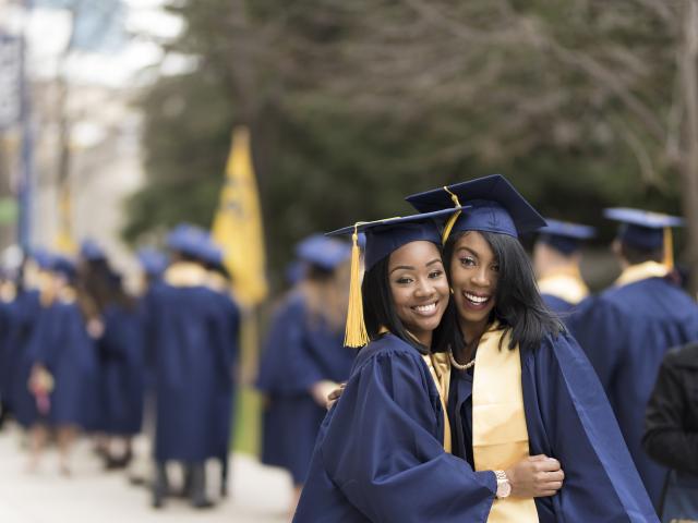 Two GRCC graduates in their cap and gowns