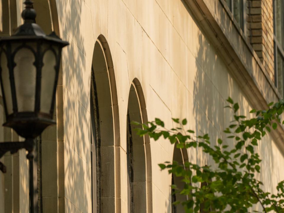 An exterior wall of a building with arched windows.