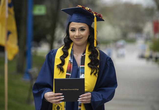Student holding diploma at commencement