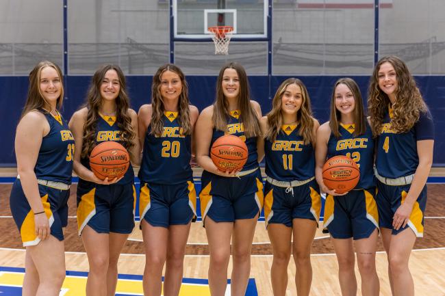 Members of the women's basketball team posing in a row. 