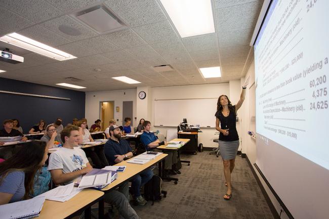 A woman explains accounting principals to a classroom of GRCC students.