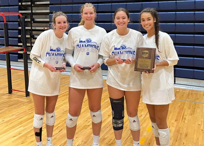 GRCC volleyball players named to the All-Tournament Team holding their trophies.
