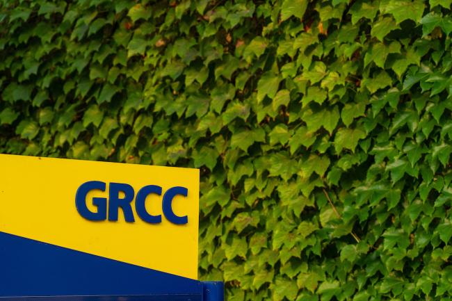 A blue and yellow GRCC sign on campus.