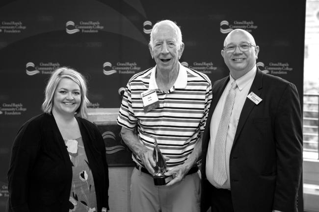 Dick Bezile pictured standing next to Erin Van Egmond and GRCC President Charles Lepper.