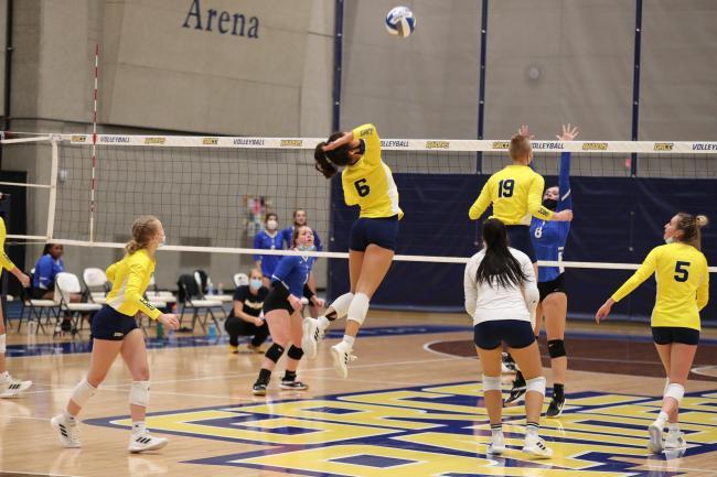 Volleyball player jumping up for a spike.