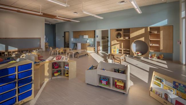 A room at the GRCC preschool with shelves and toys.