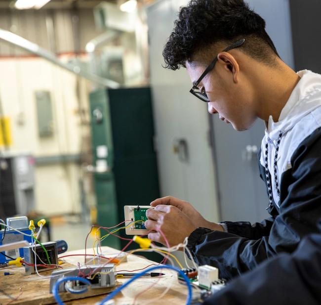 A GRCC student studies HVACR technology.