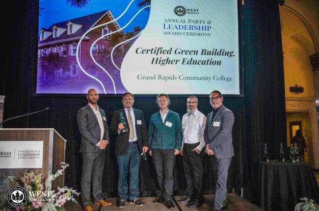 Leaders from Pioneer Construction, GRCC, and Progressive AE accepting the award from the US Green Building Council of West Michigan.
