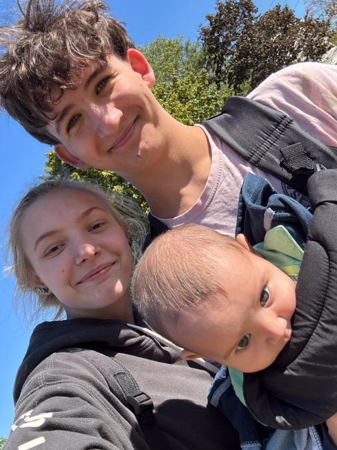 GRCC student Tyler Conger poses in a photo with his girlfriend and son.