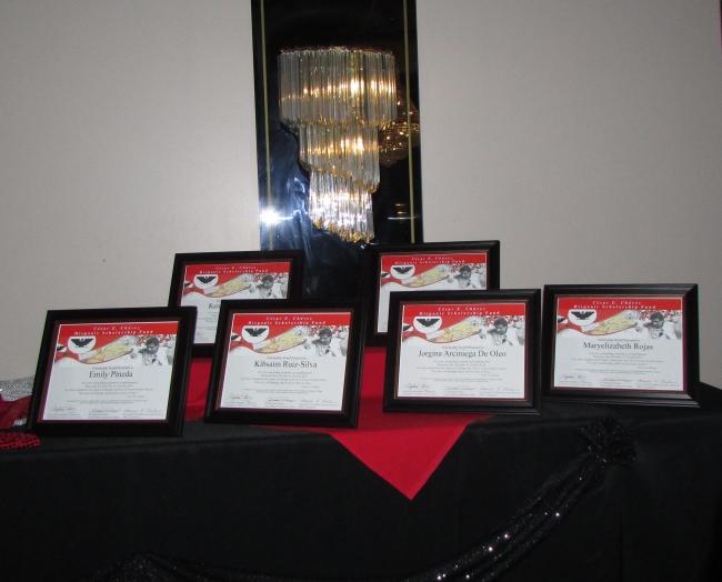Framed award certificates on a table.