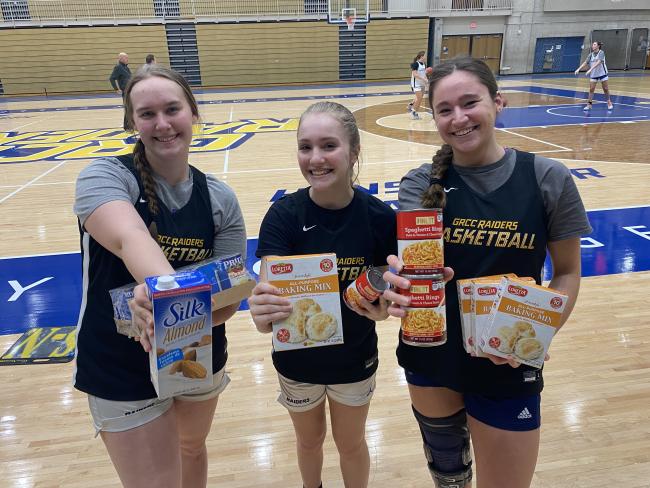Basketball players holding food items.