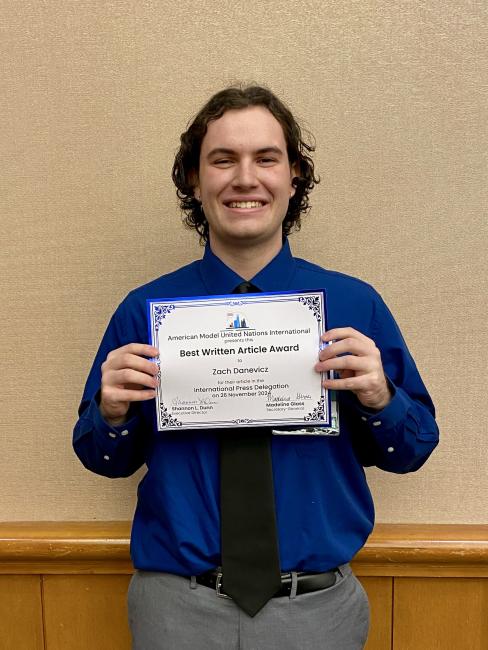 GRCC graduate Zach Danevicz holds his award for best written article from the Model U.N.