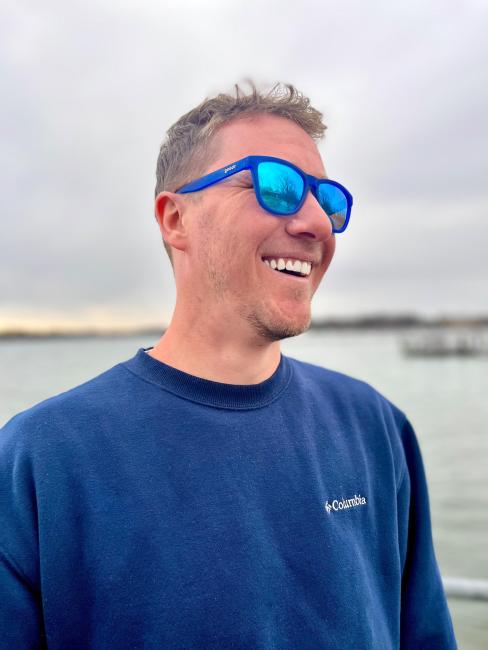 GRCC Student John Miedema pictured outside near a body of water.