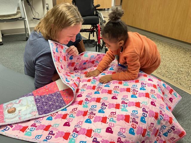 Julie Sizemore showing Island her new quilt. 