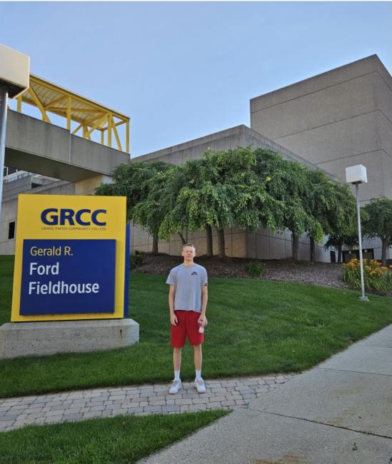 GRCC student Nicolas Knuutila poses next to GRCC's Gerald R. Ford Fieldlhouse.