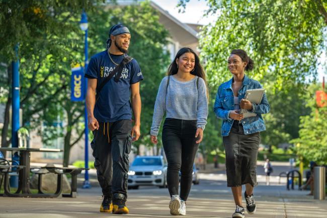Three GRCC students attending through the Grand Rapids Promise Zone walking on campus.