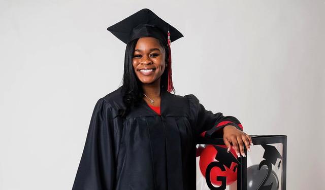 GRCC student Jada Swan poses in a black graduation cap and gown.