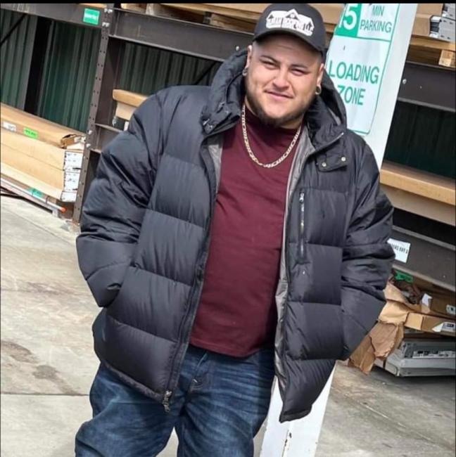 GRCC Job Training Program alumnus Victor Duran stands outside in lumberyard.