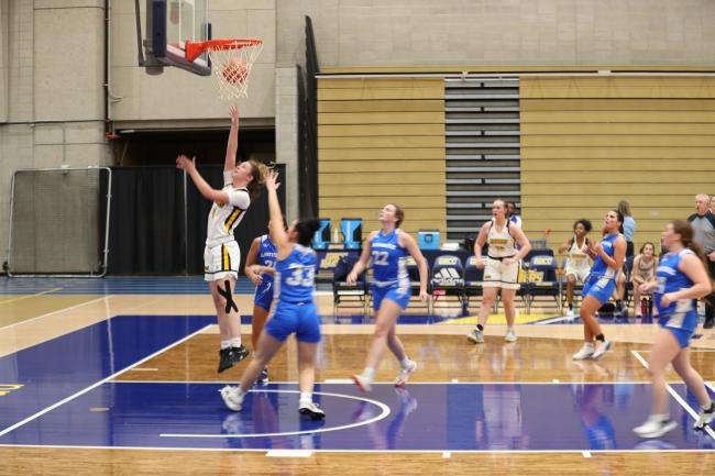 Women's team in action under the basket.