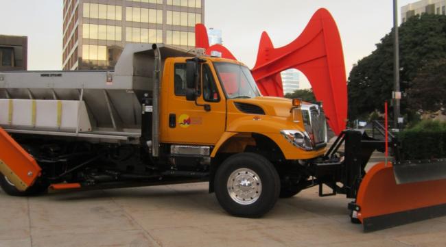 A Grand Rapids municipal dump truck is parked by the Calder statue.