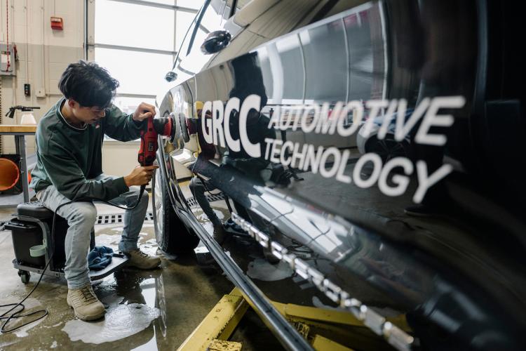 A students works on a vehicle as part of GRCC's automotive training program
