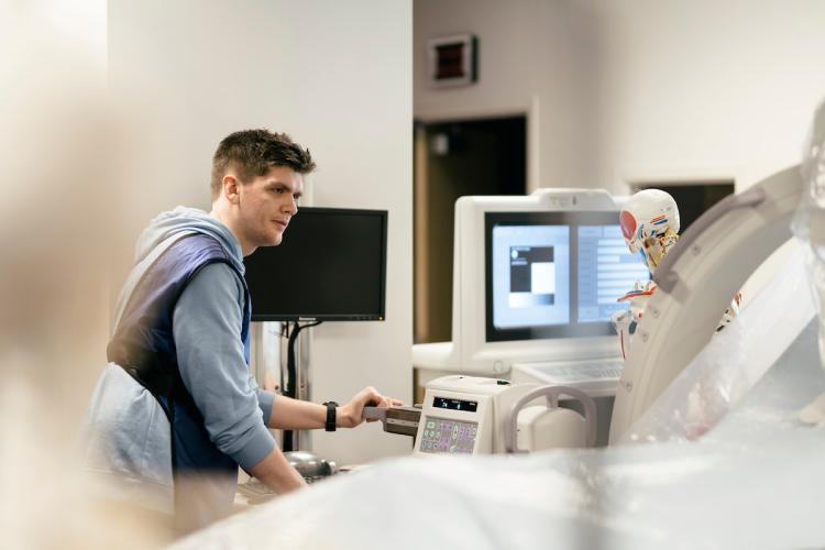 A male student looks at imaging technology in a lab at Grand Rapids Community College.