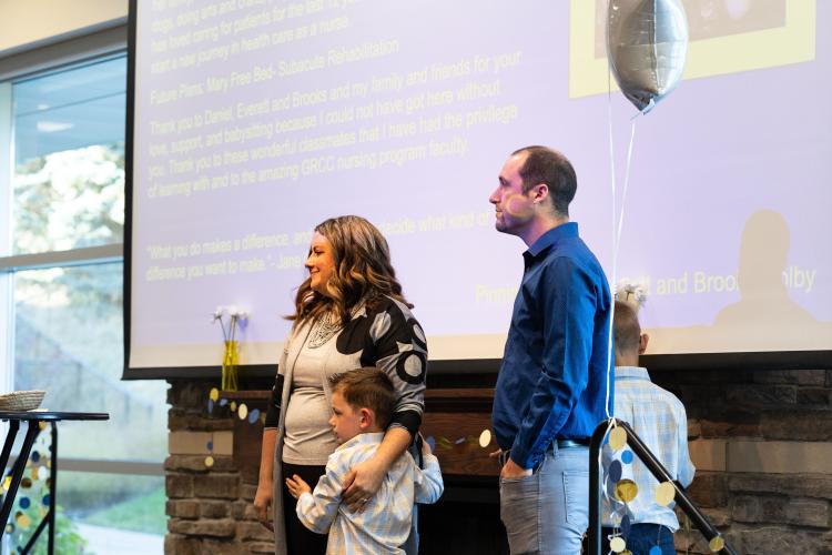 A Practical Nursing certificate graduate receives the honor with family.