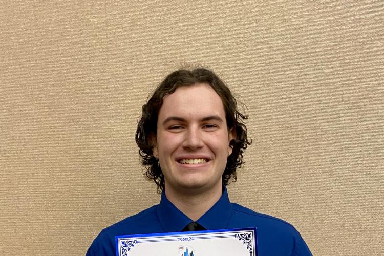 GRCC graduate Zach Danevicz holds his award for best written article from the Model U.N.