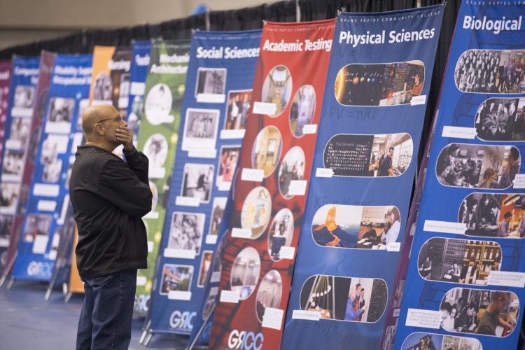 A man looks at the timeline banners during GRCC's 100th anniversary Community Picnic.