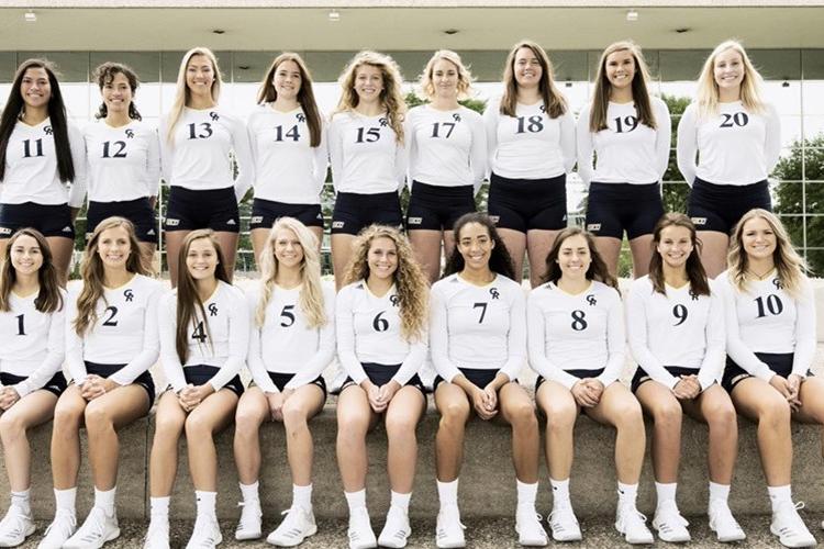 Members of the 2018-19 volleyball team stand in front of the Gerald R. Ford Museum.