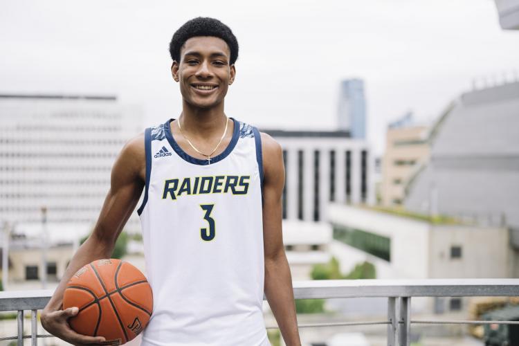 Andrew Moore posing with a basketball.