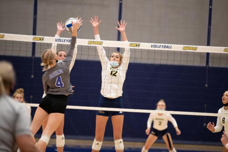 Annie Holesinger in action, jumping to block a shot.