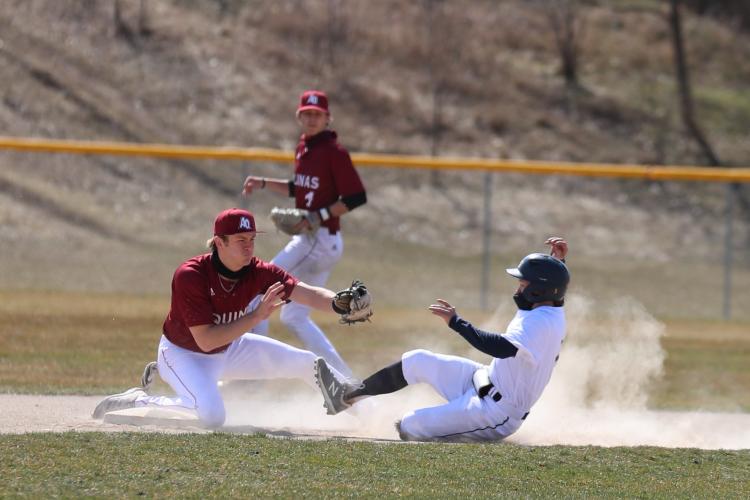 A GRCC Raider sliding into second base.