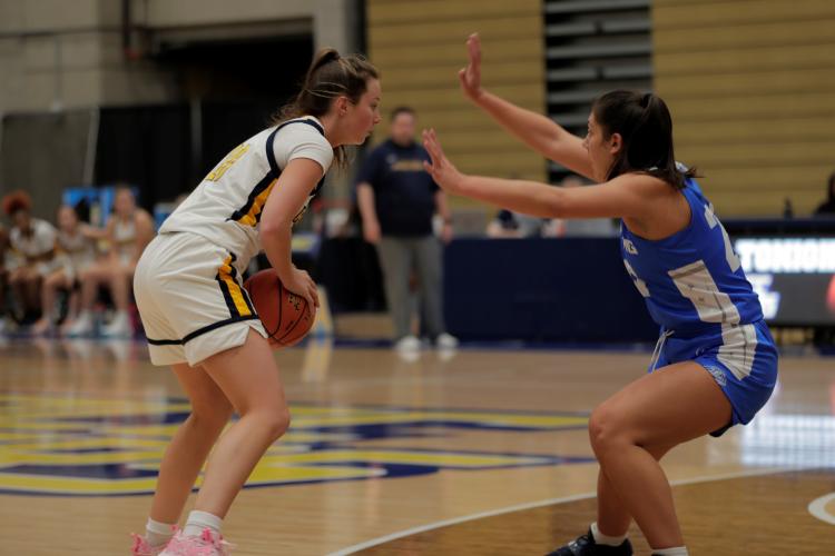 Basketball player trying to get around a defender.