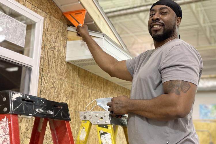 Derrick Peoples working on building a shed.