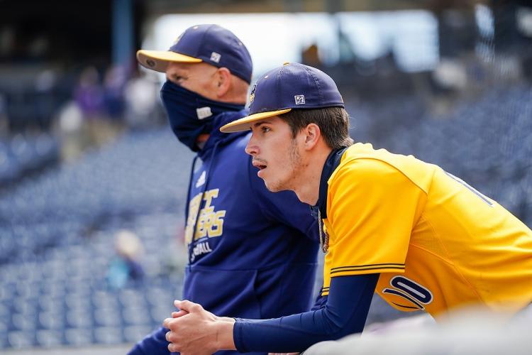 Drew Murphy and coach Mike Eddington in the dugout.