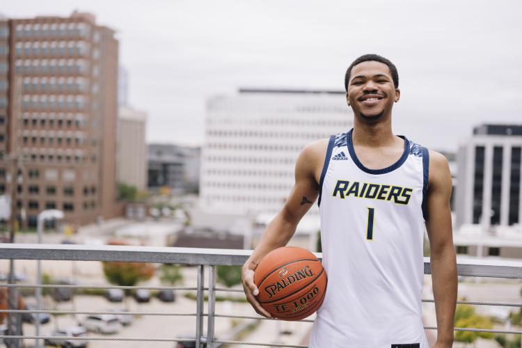 GRCC basketball player Justus Clark holding a ball.