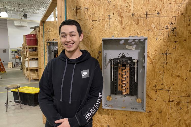 Photo of Alec Alvarado posing in the construction electrical lab.