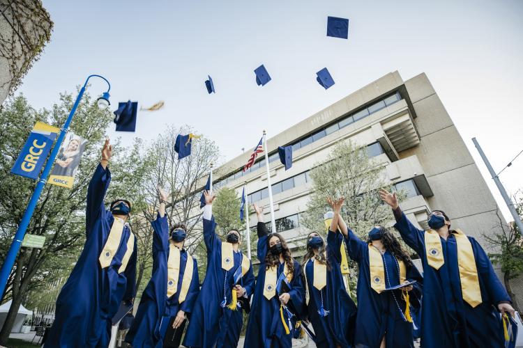 Graduates throwing their caps into the air after commencement.