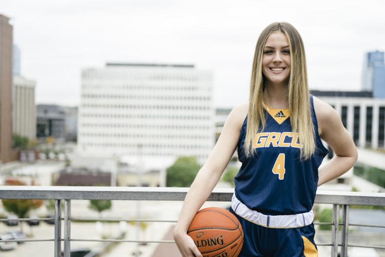 Grace Lodes posing with a basketball.