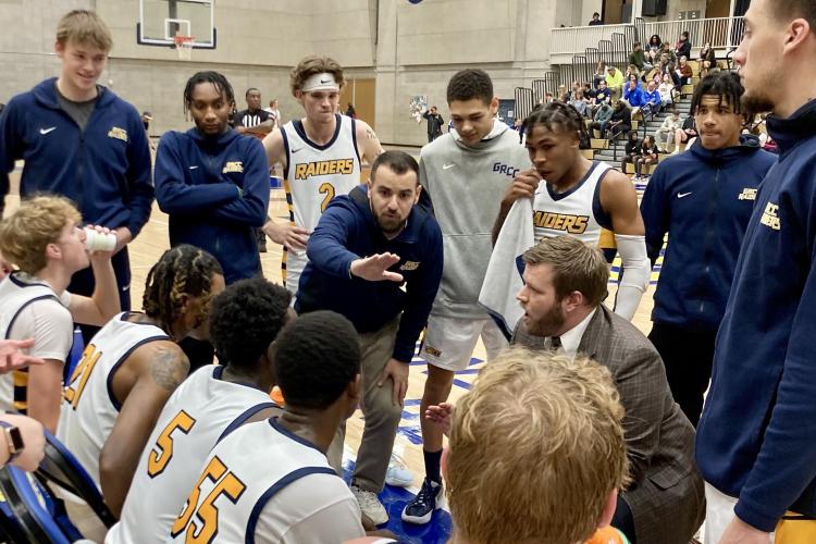 Islam Hoxha talking to the basketball team during a timeout.