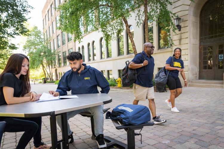 Students studying and walking on Olivarez Plaza.