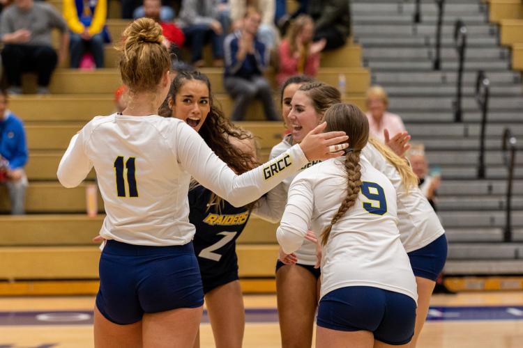 GRCC volleyball players celebrating.