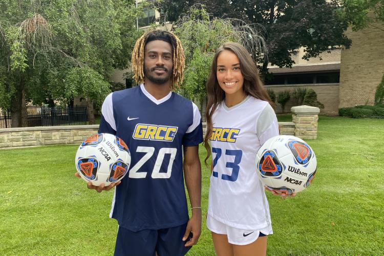 GRCC student-athletes Rico Wade and Audrey Torres with soccer balls.