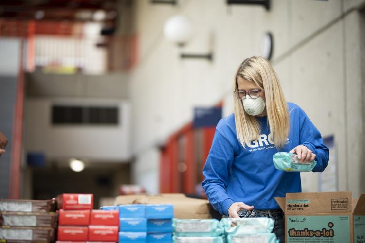 GRCC staffer Sandy Gregory packing bags of food for students.