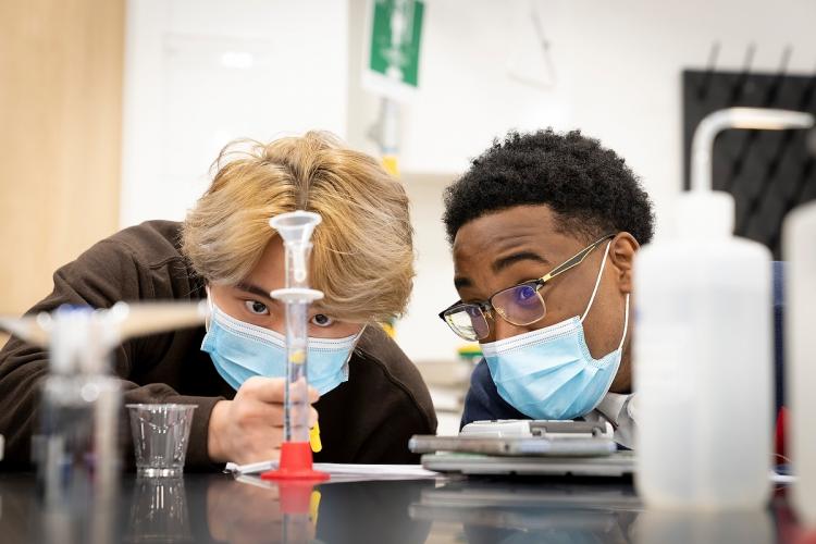 Students in a physical science class working on an experiment.