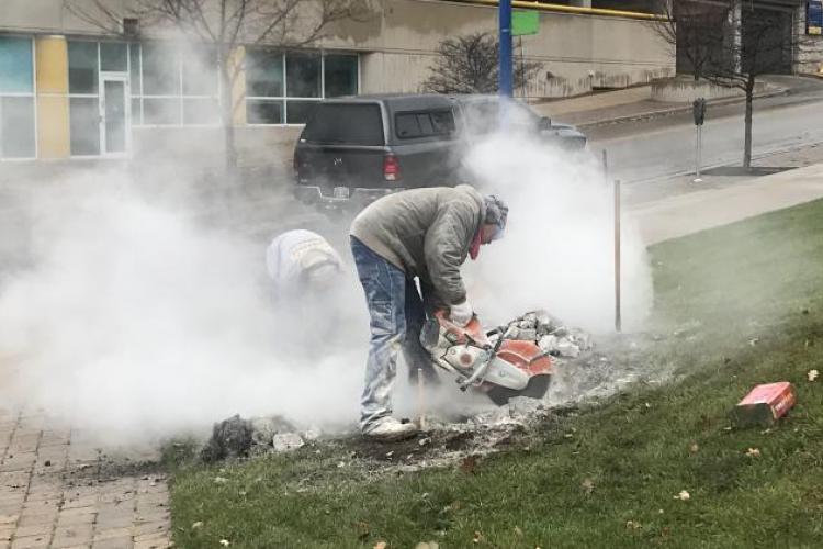 Demolition of one of the old, blue triangle signs.