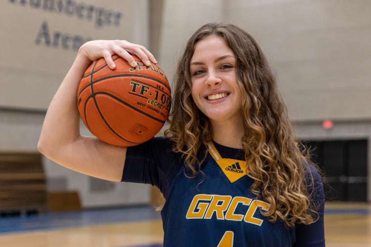 Grace Lodes posing with a basketball.