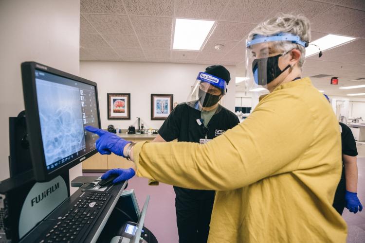 Heather Klare and a student looking at an x-ray.