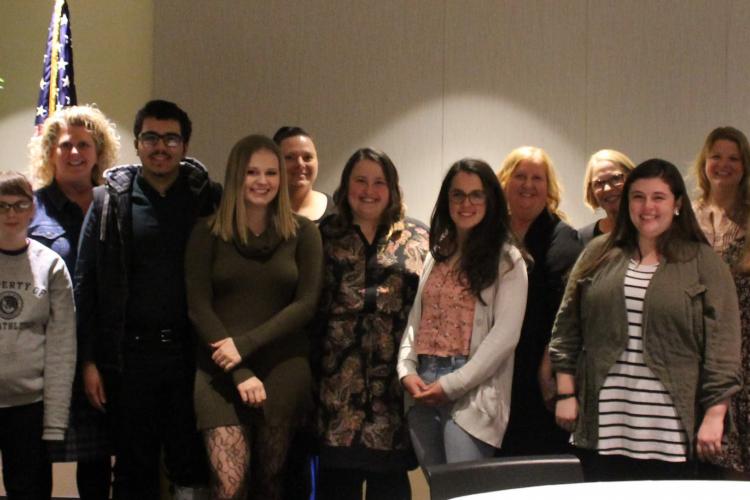 Scholarship recipients stand in a line.